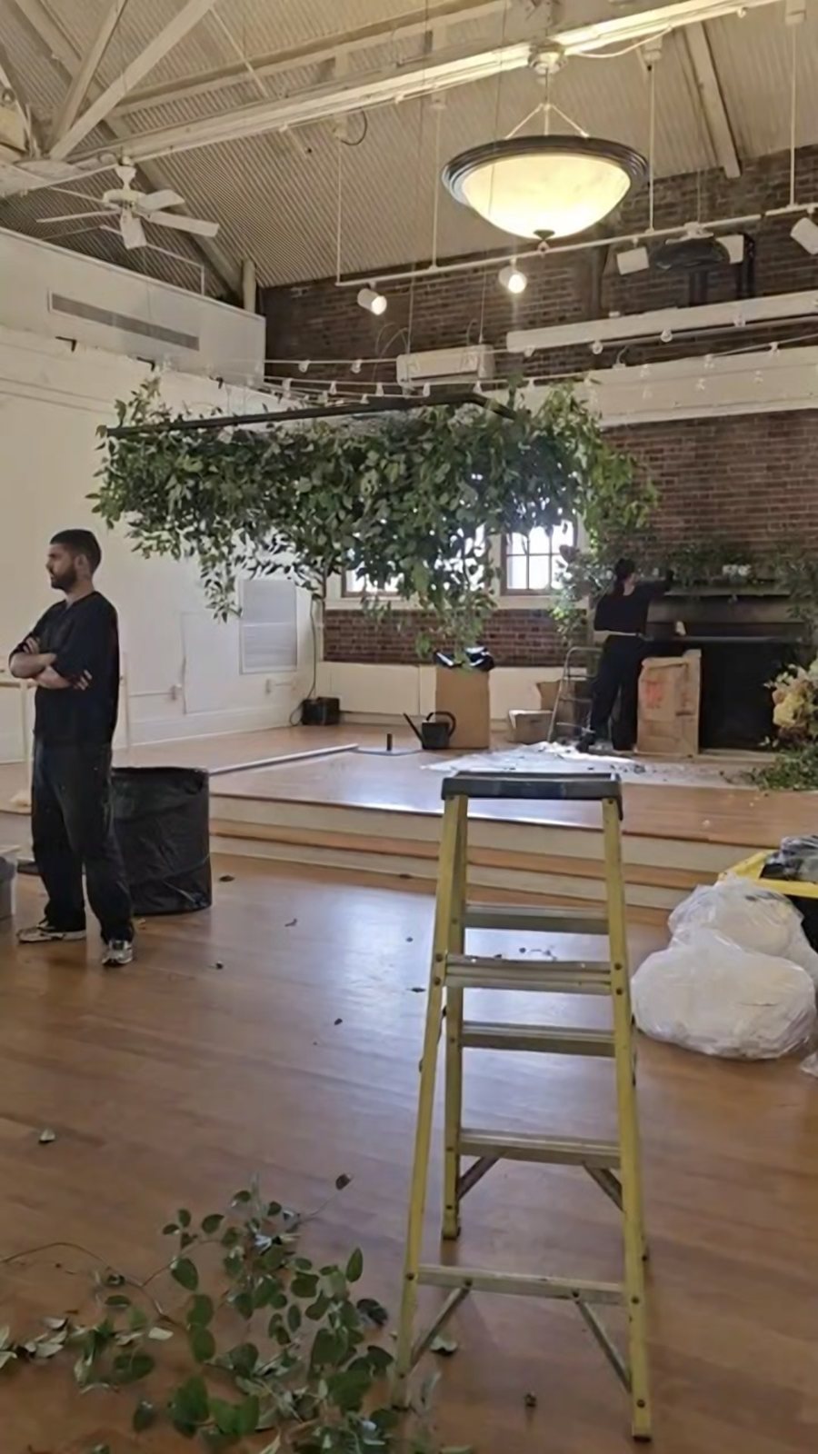 Crew building a suspended greenery installation