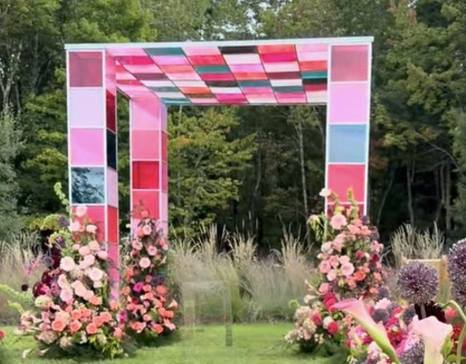 The finished welded chuppah installed on a lawn with floral aisle arrangements