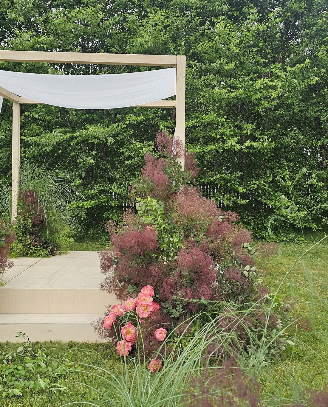 Light wood chuppah + ceremony stage
