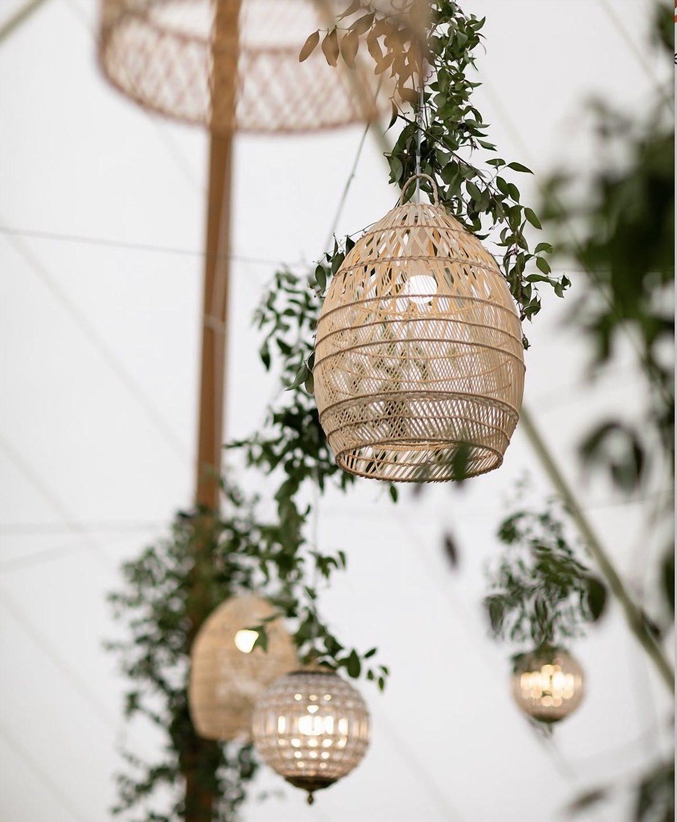 Rattan lanterns and a crystal chandelier rigged from a tent ceiling