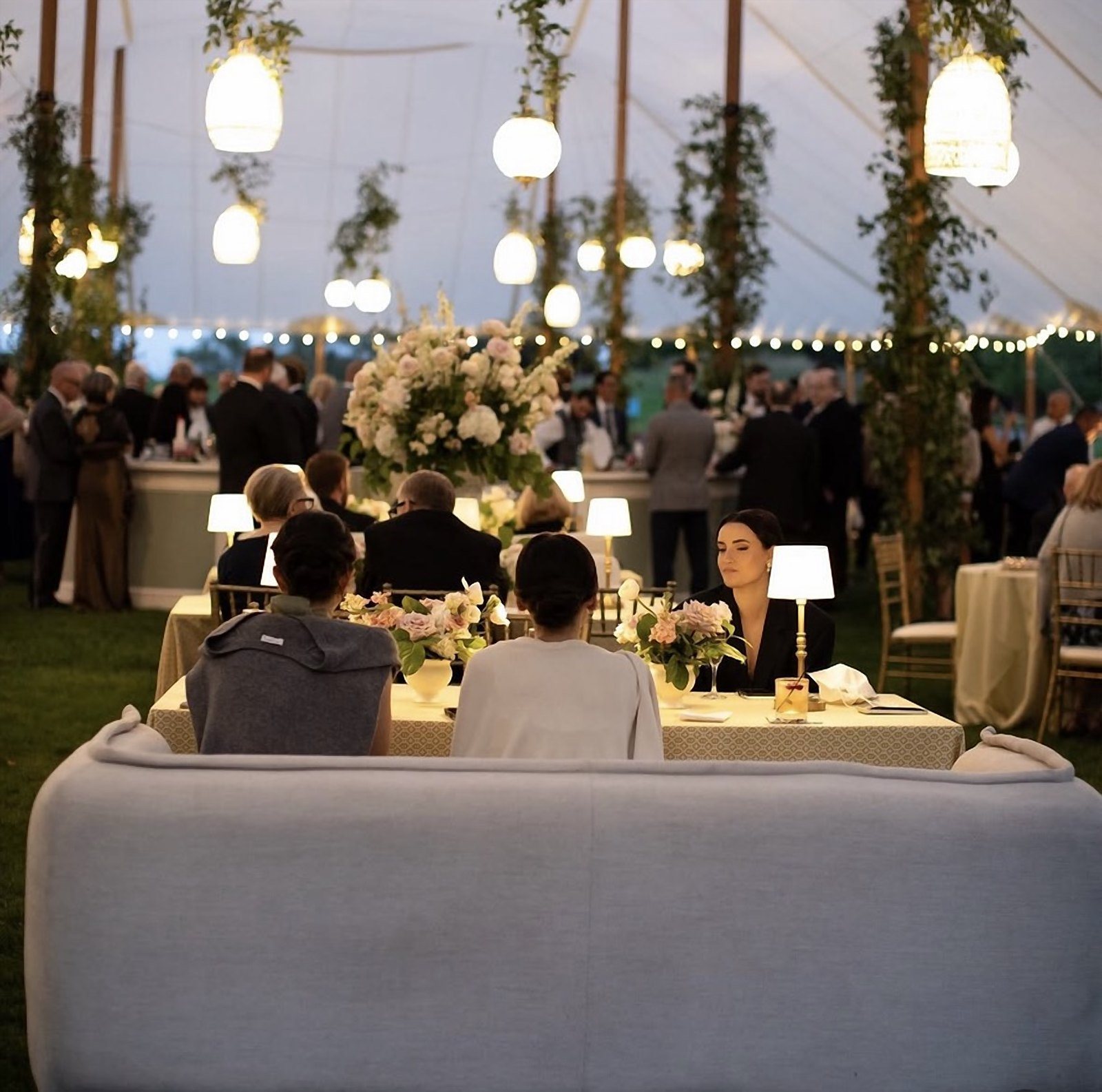 Candlelit lounge seating under a canopy of rigged globe lights