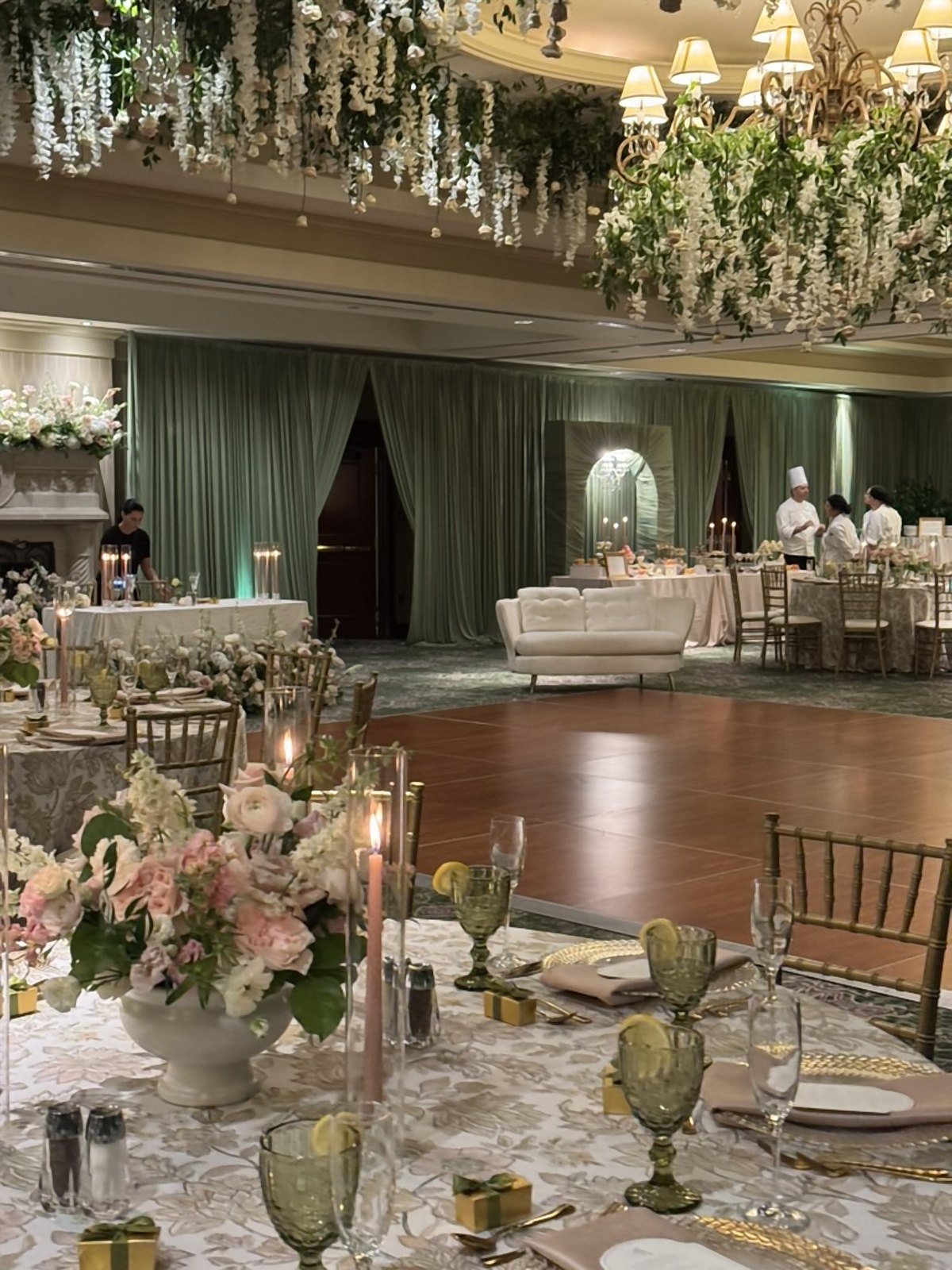 Ballroom reception with a suspended wisteria ceiling, lounge seating and candlelit tables