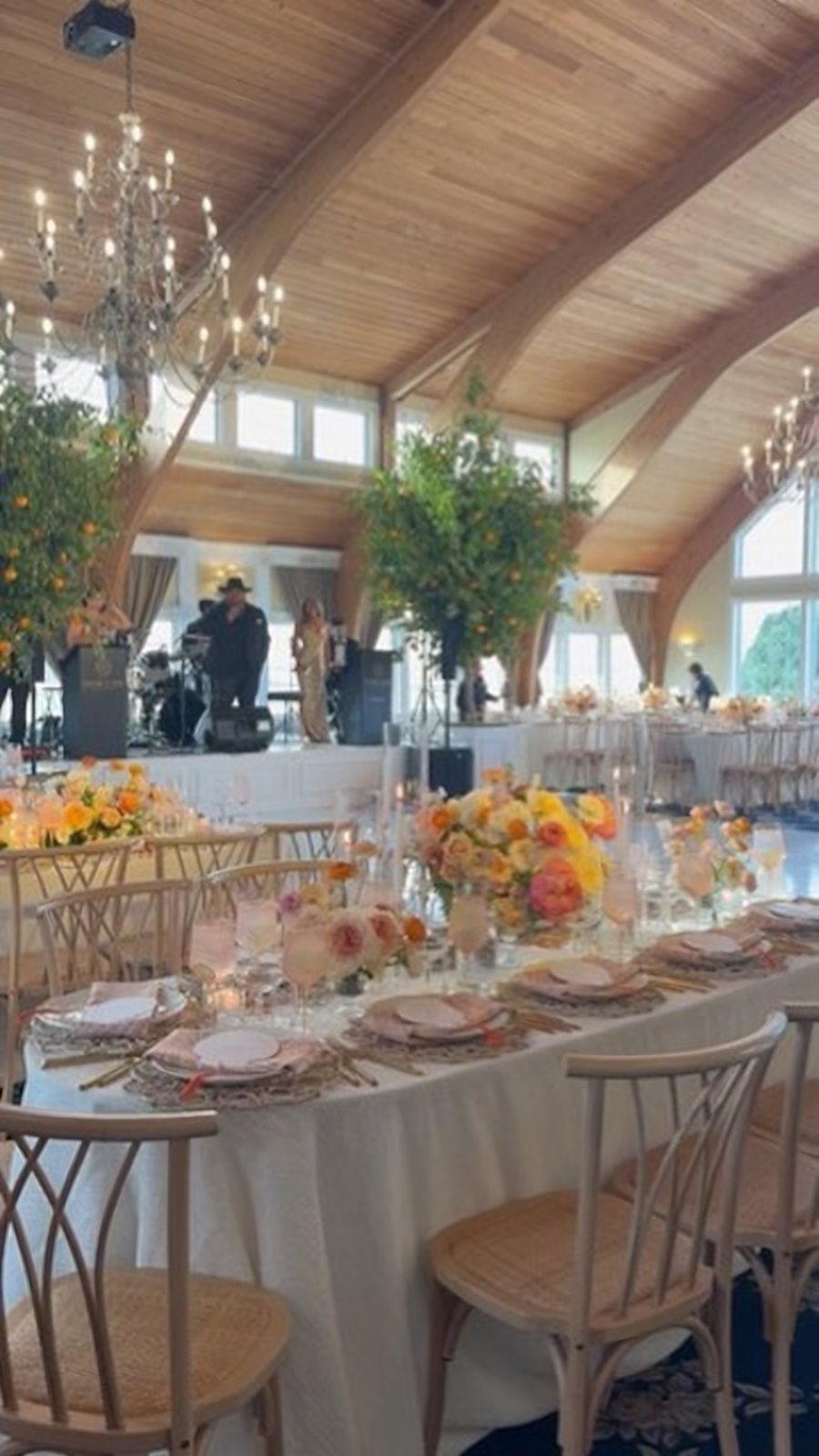 Finished reception with orange trees flanking the stage